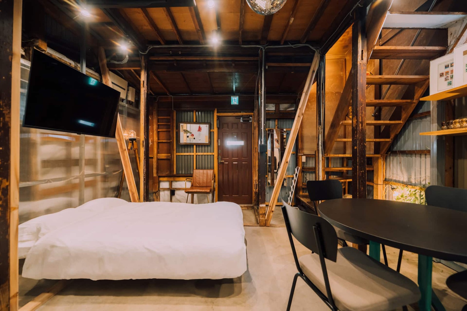 Ivy Place Harajuku — Living room with dining table and sofa bed, ivy on the walls