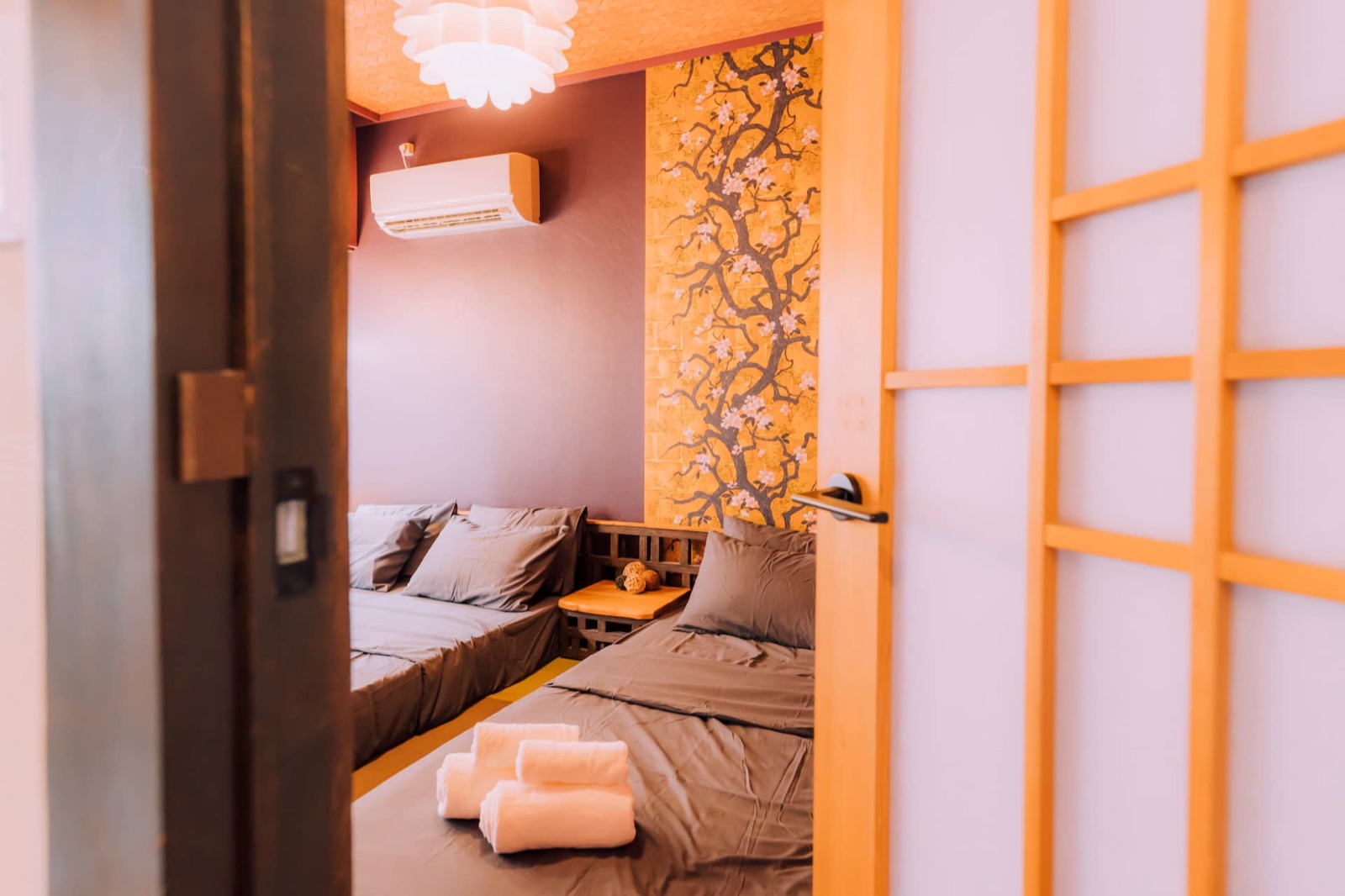 Shinobi House — Bedroom — low platform beds and muted colours
