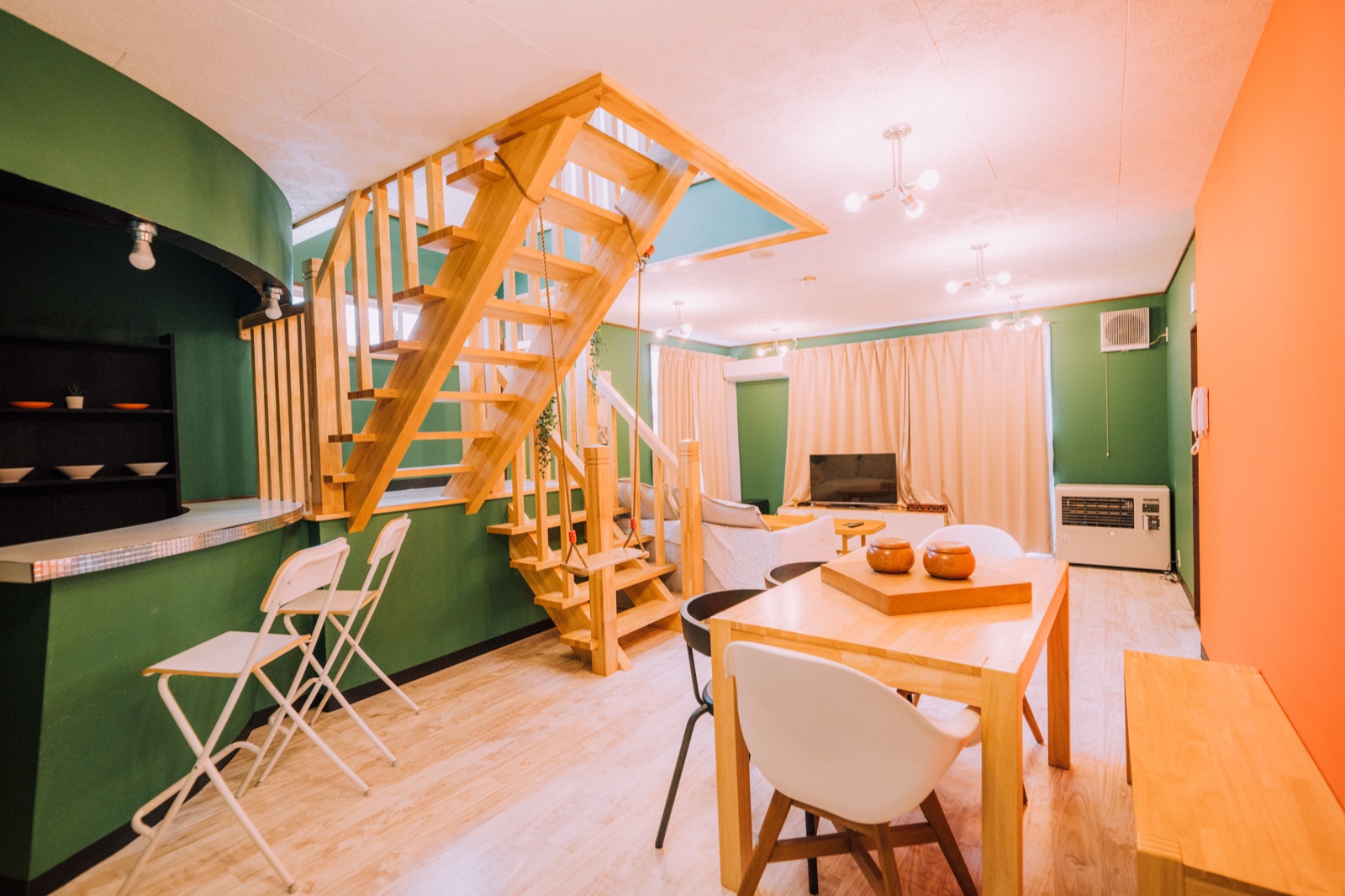 Yuzawa Onsen Lodge — House B dining table under the staircase
